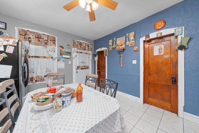 dining room featuring light tile patterned floors and ceiling fan