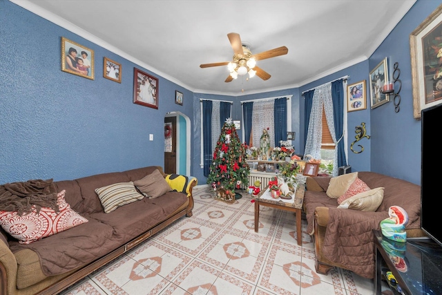 living room featuring crown molding and ceiling fan