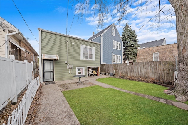 rear view of house with a yard and a patio