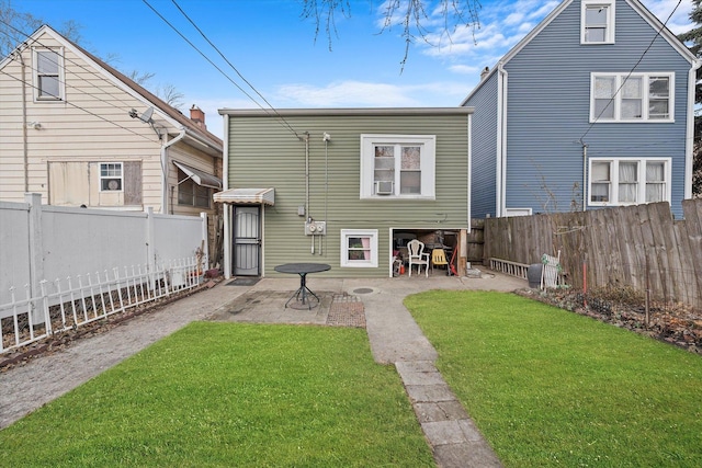 rear view of property with a lawn and a patio