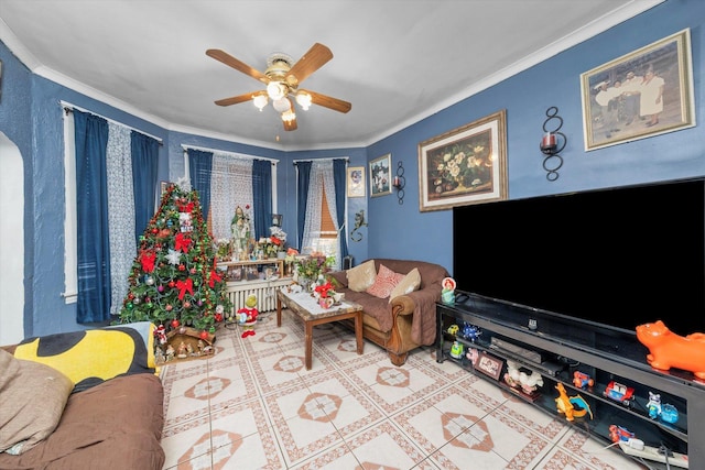 tiled living room featuring ceiling fan and crown molding