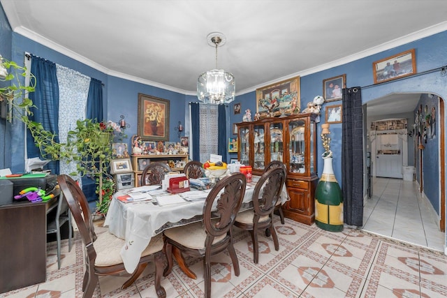 dining area featuring light tile patterned flooring, ornamental molding, and a chandelier