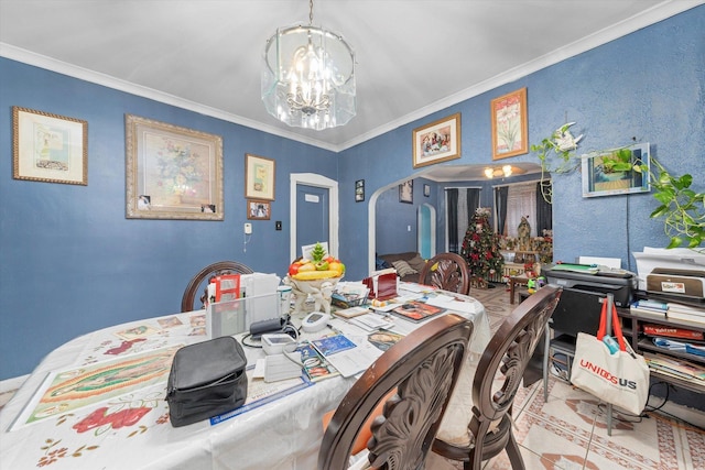 dining space with crown molding and a chandelier