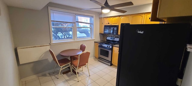 kitchen with light brown cabinetry, tasteful backsplash, ceiling fan, black appliances, and light tile patterned floors