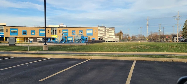 view of car parking featuring a lawn