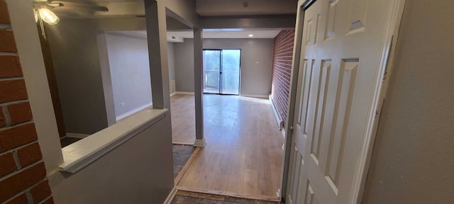 corridor with hardwood / wood-style floors