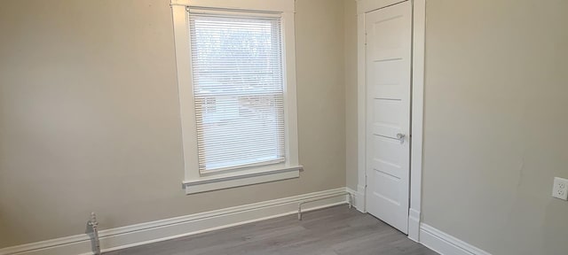 unfurnished room with light wood-type flooring