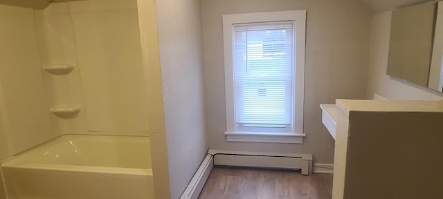 bathroom featuring baseboard heating and hardwood / wood-style flooring