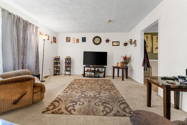 living room featuring light carpet and a textured ceiling