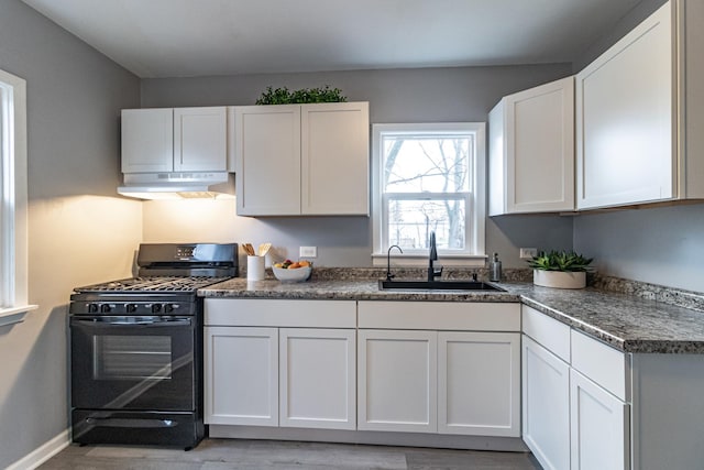 kitchen with white cabinets, gas stove, and sink