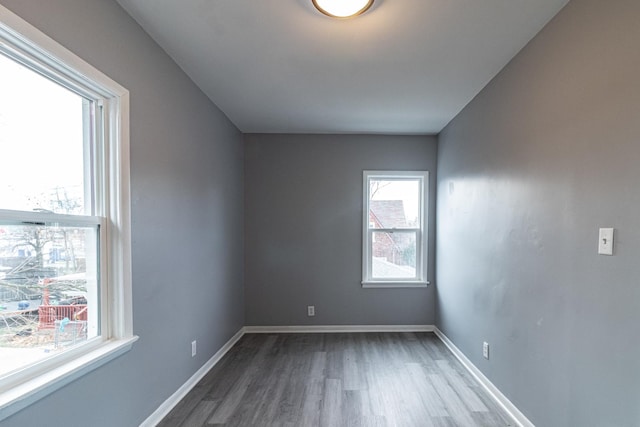 unfurnished room with wood-type flooring