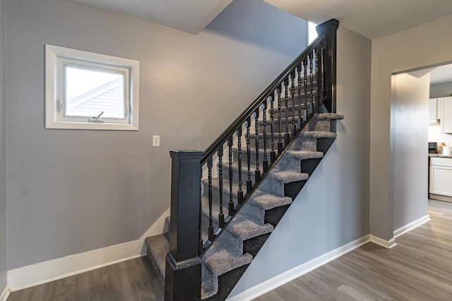 stairs with wood-type flooring