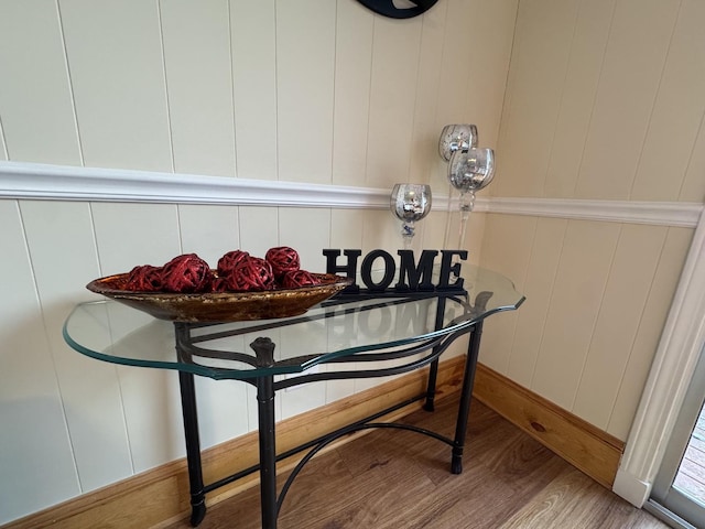 room details featuring hardwood / wood-style floors and wood walls