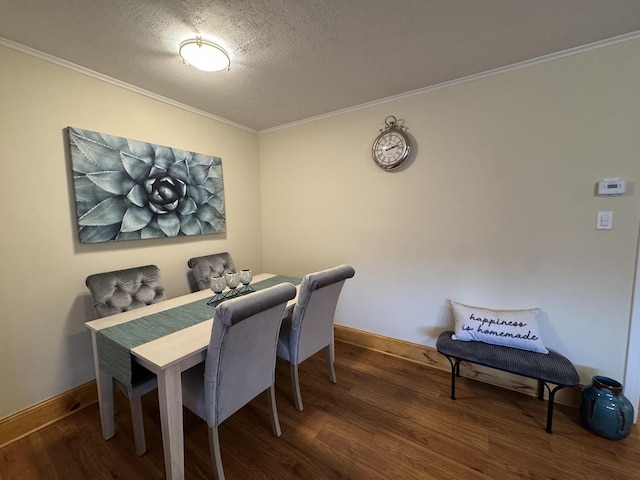 dining room featuring hardwood / wood-style floors, a textured ceiling, and ornamental molding