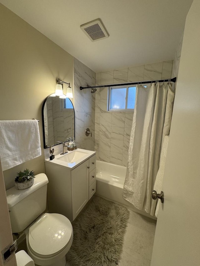 full bathroom featuring vanity, shower / bath combo, and toilet