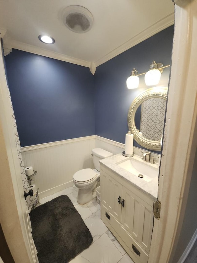 bathroom featuring vanity, toilet, and crown molding