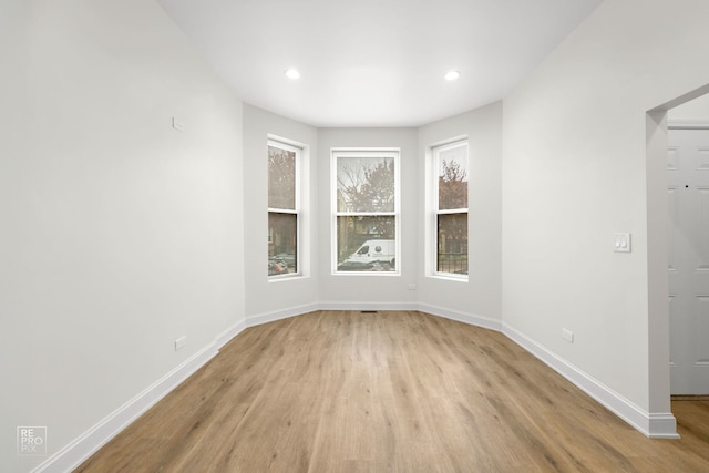 unfurnished room with light wood-type flooring