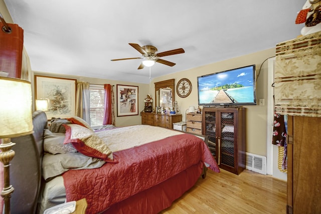 bedroom with ceiling fan and light hardwood / wood-style floors