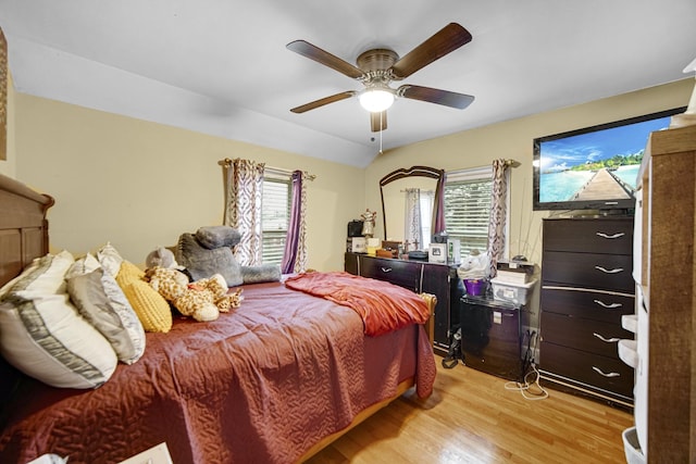 bedroom with multiple windows, ceiling fan, and light hardwood / wood-style floors