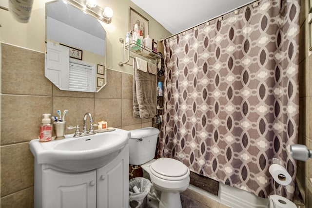 full bathroom featuring shower / tub combo with curtain, vanity, tile walls, and toilet