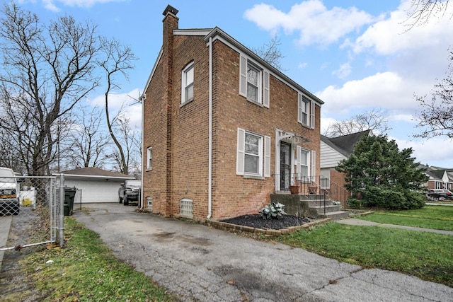 view of property exterior featuring a yard, an outdoor structure, and a garage