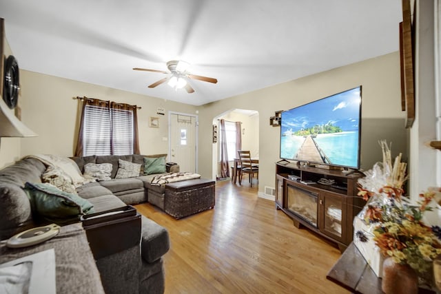 living room with ceiling fan and light wood-type flooring