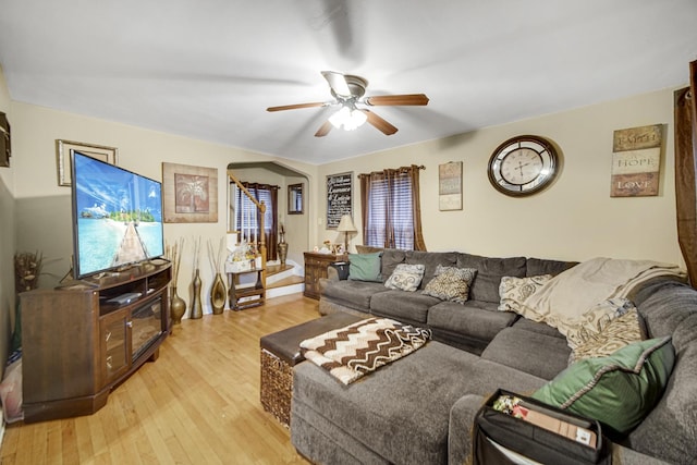 living room featuring ceiling fan and light hardwood / wood-style floors