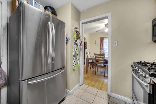 kitchen featuring ceiling fan, light tile patterned floors, and appliances with stainless steel finishes