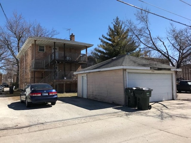 exterior space featuring a balcony and a garage