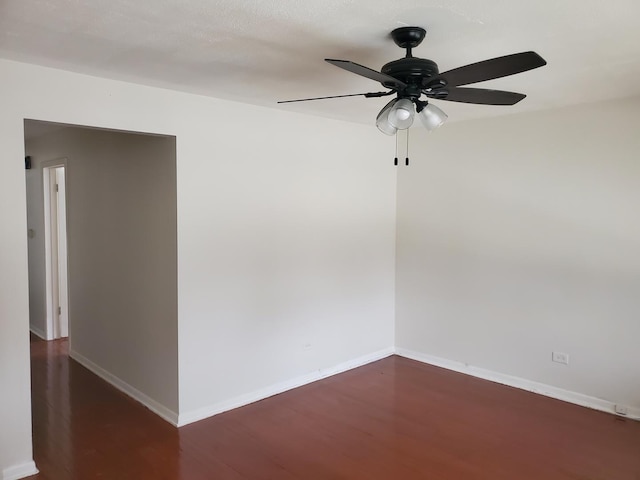 spare room featuring ceiling fan and dark hardwood / wood-style floors