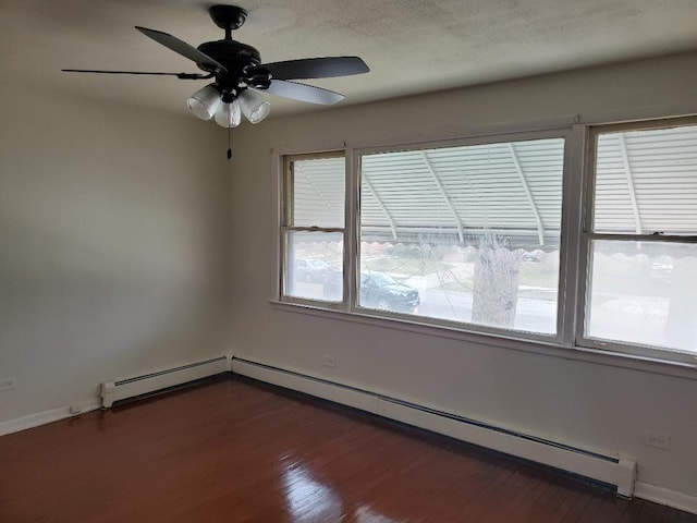 empty room with a textured ceiling, a baseboard radiator, ceiling fan, and dark wood-type flooring