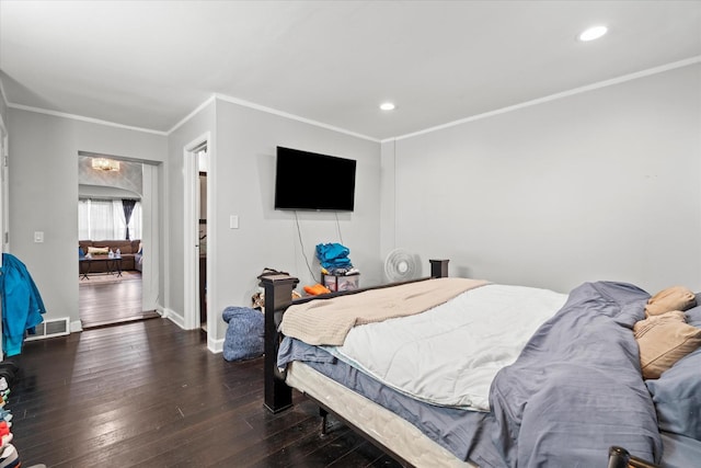 bedroom with dark hardwood / wood-style floors and ornamental molding