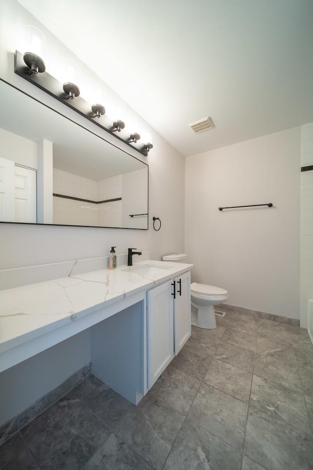 bathroom featuring vanity and toilet