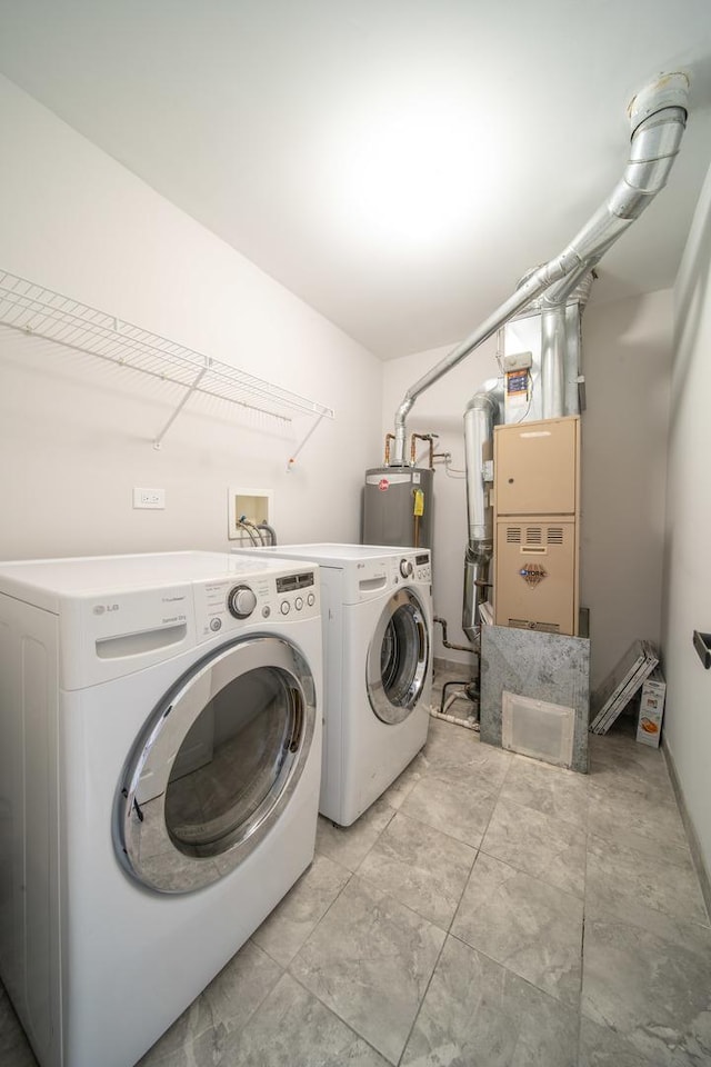 laundry area with water heater and washing machine and clothes dryer