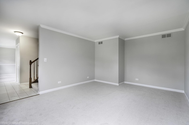 carpeted spare room featuring ornamental molding