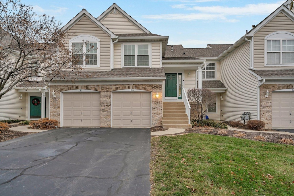 view of front of home featuring a garage and a front lawn