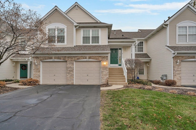 view of front of home featuring a garage and a front lawn