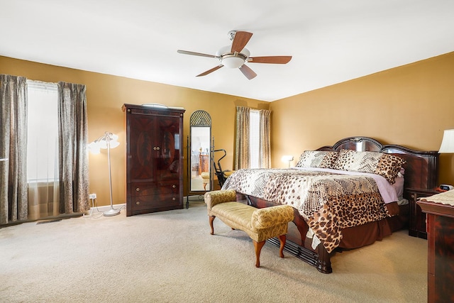 bedroom with ceiling fan and light colored carpet