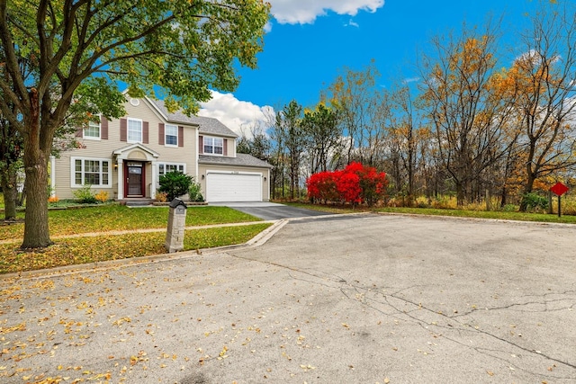 view of front of house featuring a garage and a front yard