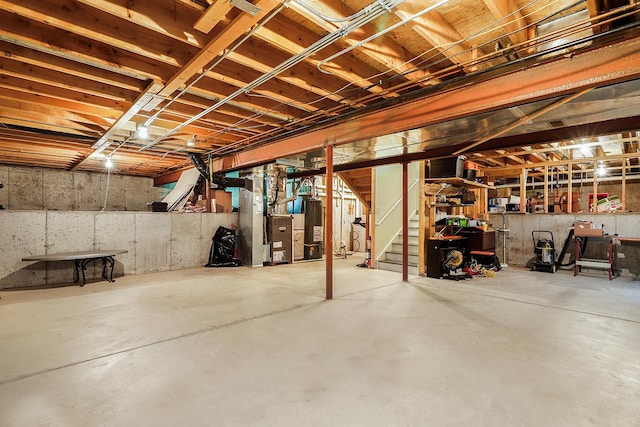 basement featuring heating unit and water heater