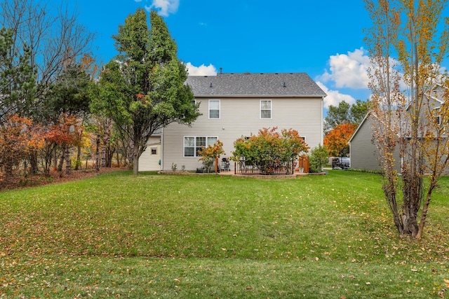 rear view of house with a lawn