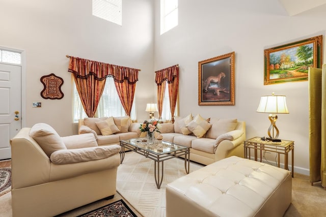 living room featuring a towering ceiling and light carpet