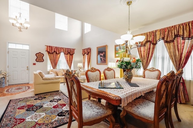 dining room featuring an inviting chandelier and a towering ceiling