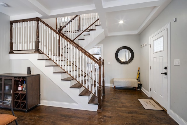 foyer with beamed ceiling, dark wood-type flooring, and coffered ceiling