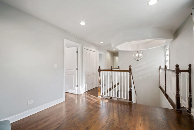 interior space featuring dark hardwood / wood-style floors and an inviting chandelier