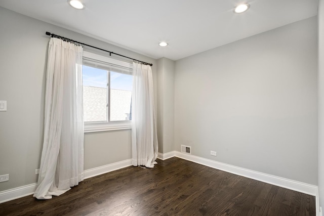 unfurnished room with dark hardwood / wood-style flooring