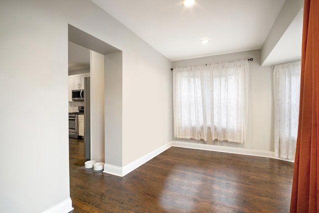 spare room featuring dark wood-type flooring