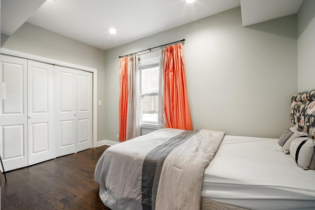 bedroom with a closet and dark hardwood / wood-style flooring