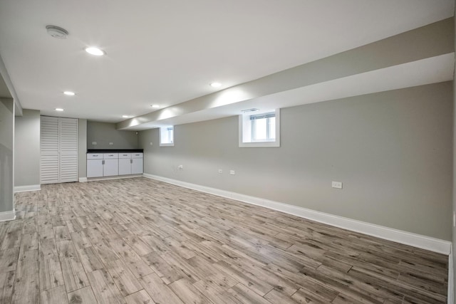 basement with light hardwood / wood-style floors