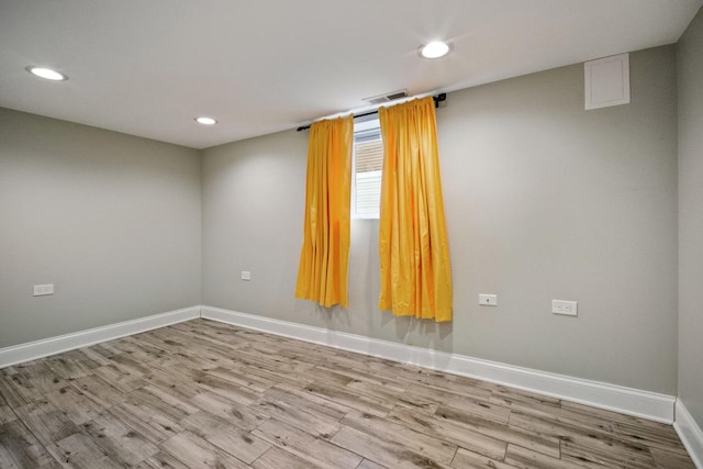 unfurnished room with light wood-type flooring